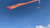 In the middle of the festival, a 3-year-old girl is carried in the air by a kite